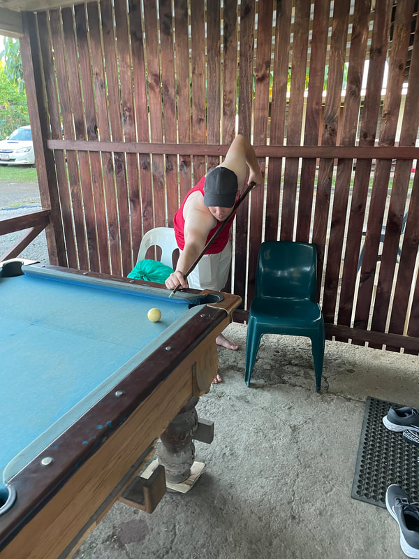 Undergraduate Grant Pethel playing pool on the table in front of our rental apartment.